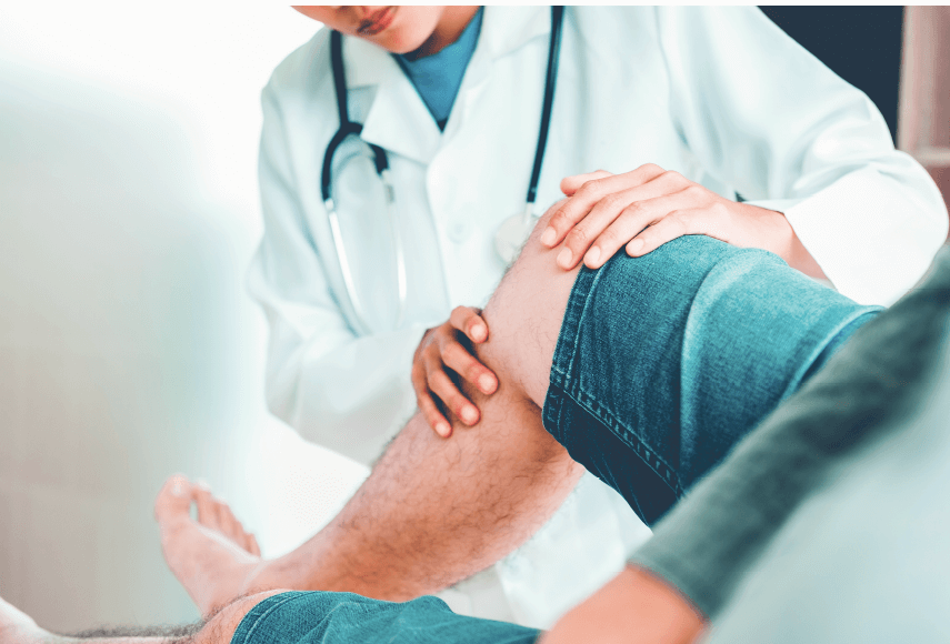 doctor helping patient with knee pain